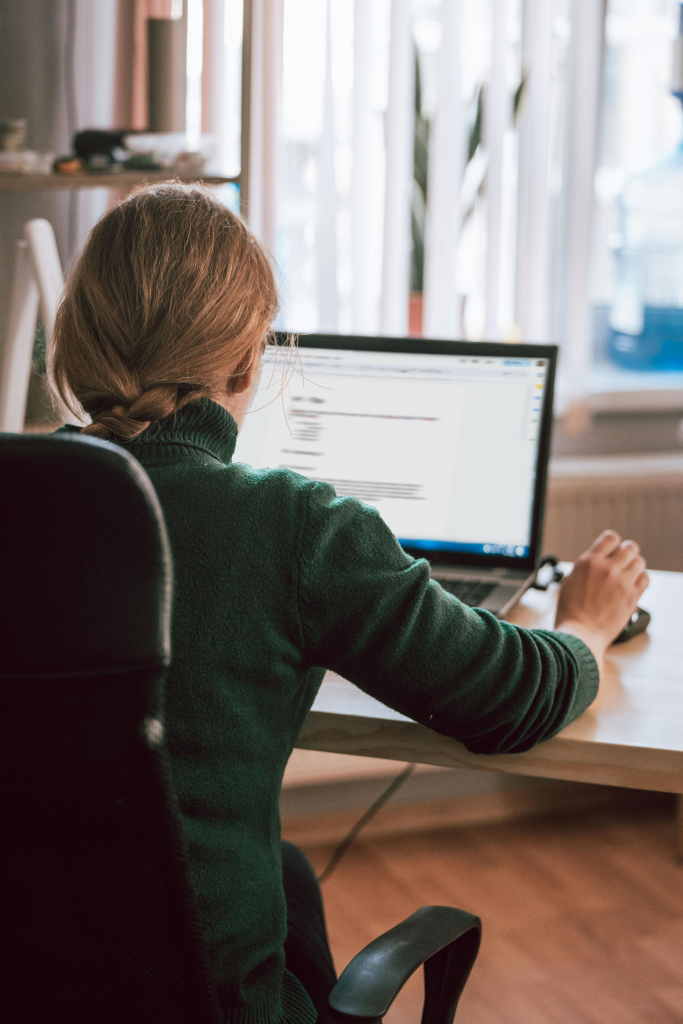 Woman writing a paper on her computer