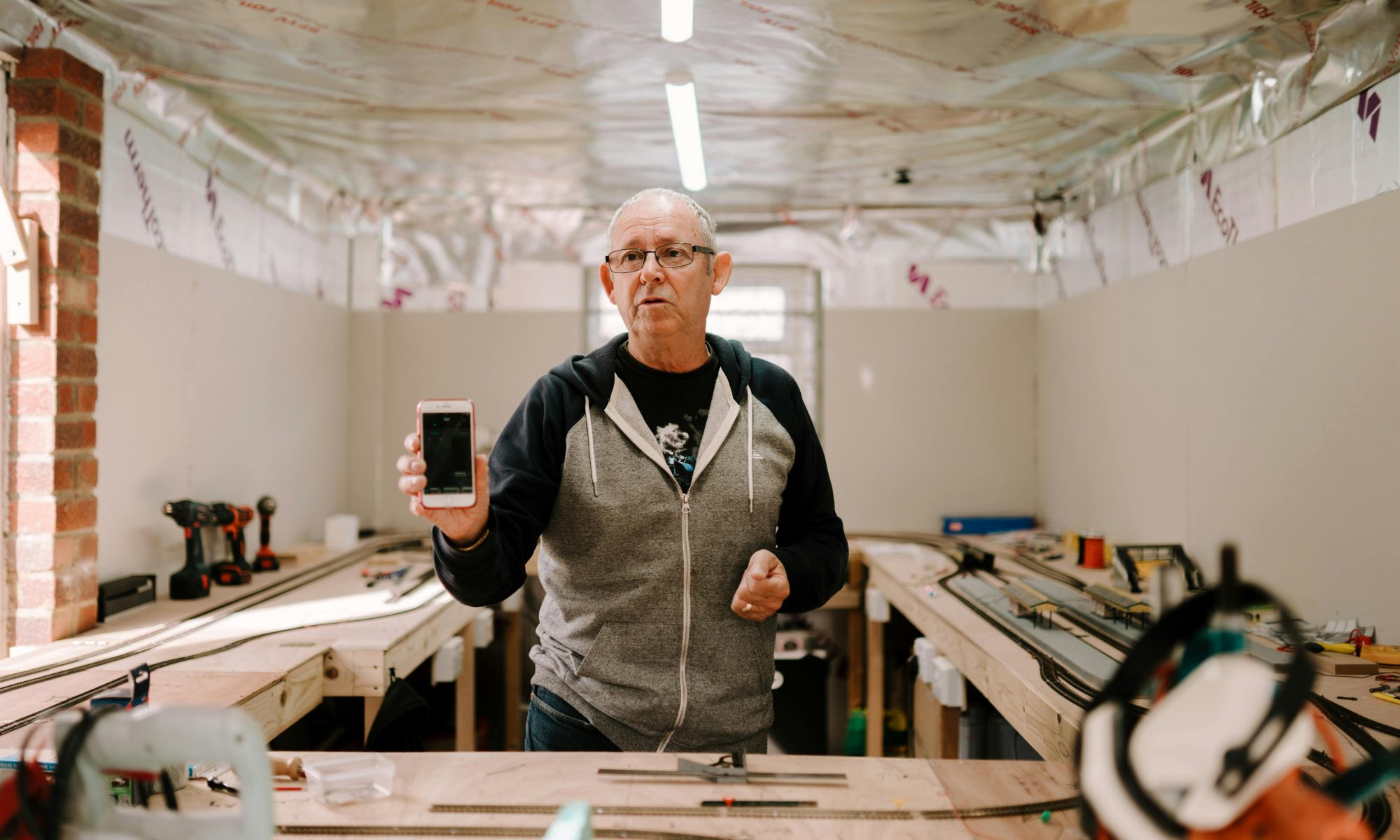 Mans give demonstrative speech in his workshop