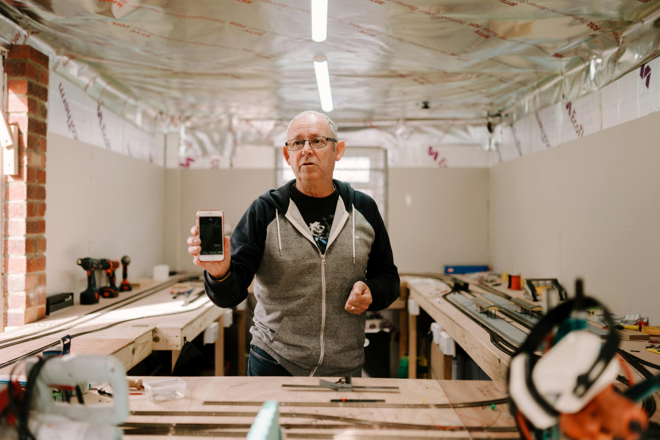 Mans give demonstrative speech in his workshop