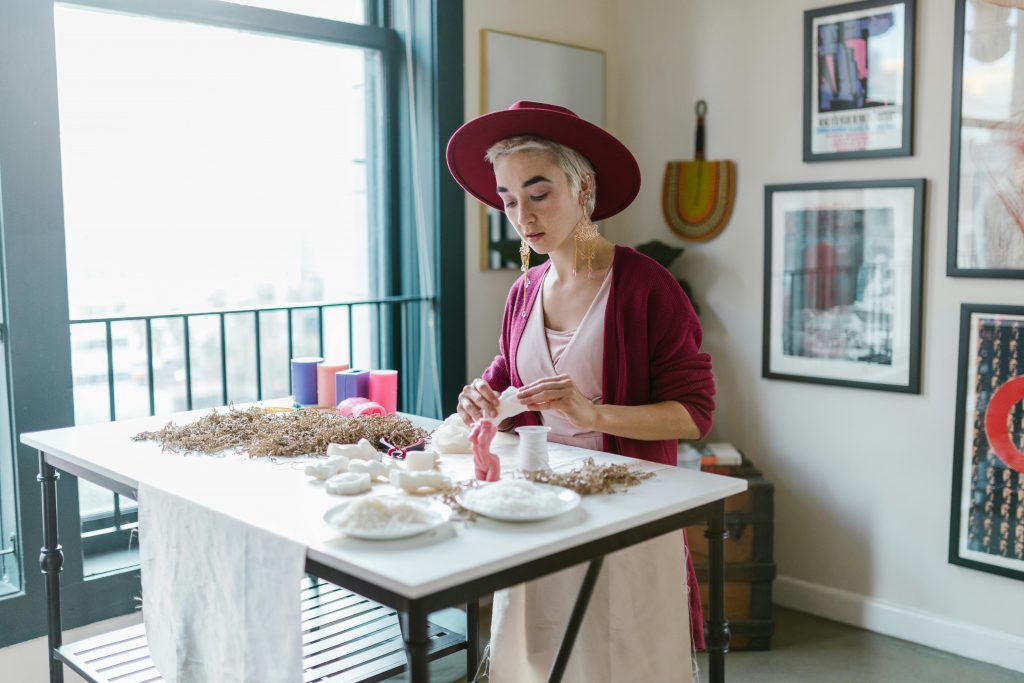 Girl creates homemade candles with eco-friendly materials