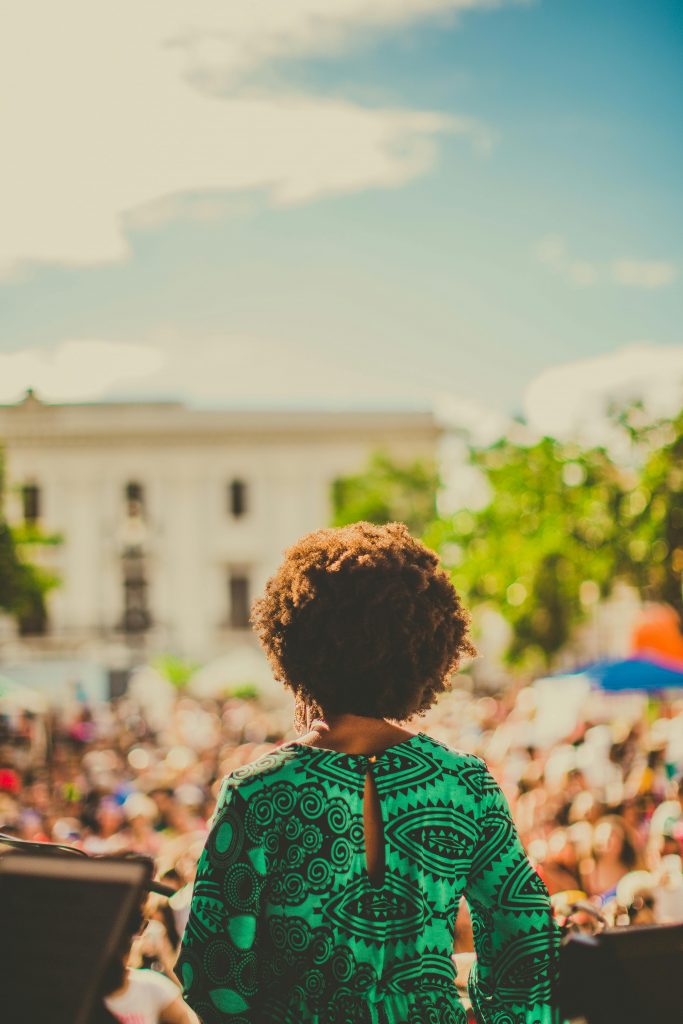 female speaker looks out at a huge crowd