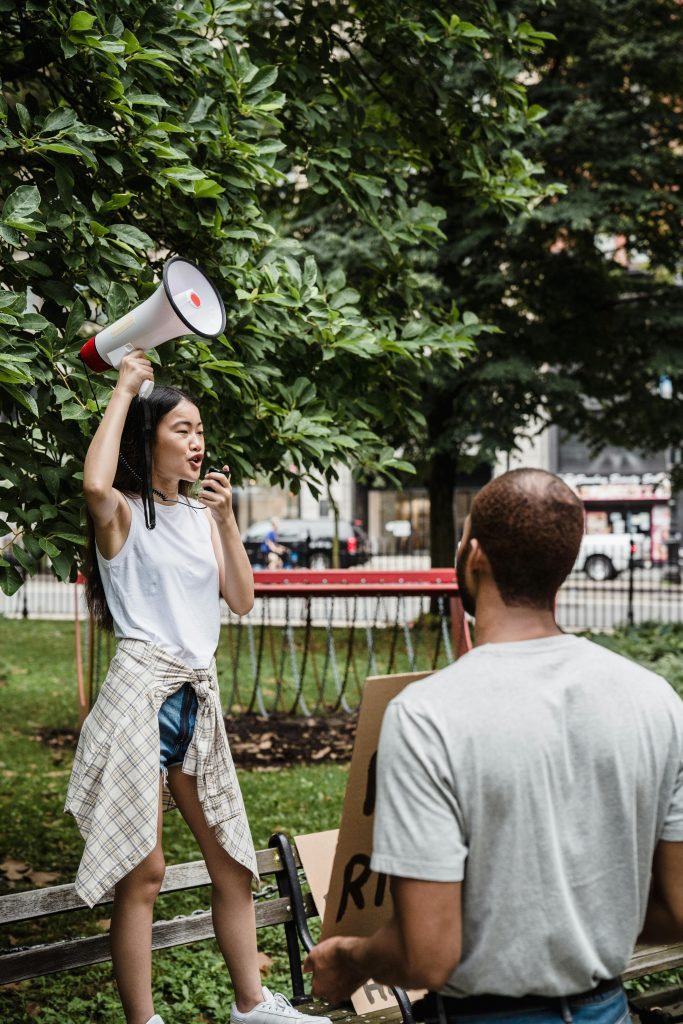 Female protester shares thoughts with microphone and bullhorn