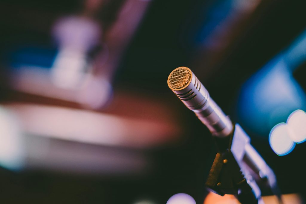 a microphone stands on an empty stage