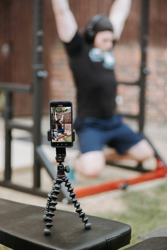 Yoga instructor records proper techniques on his smartphone